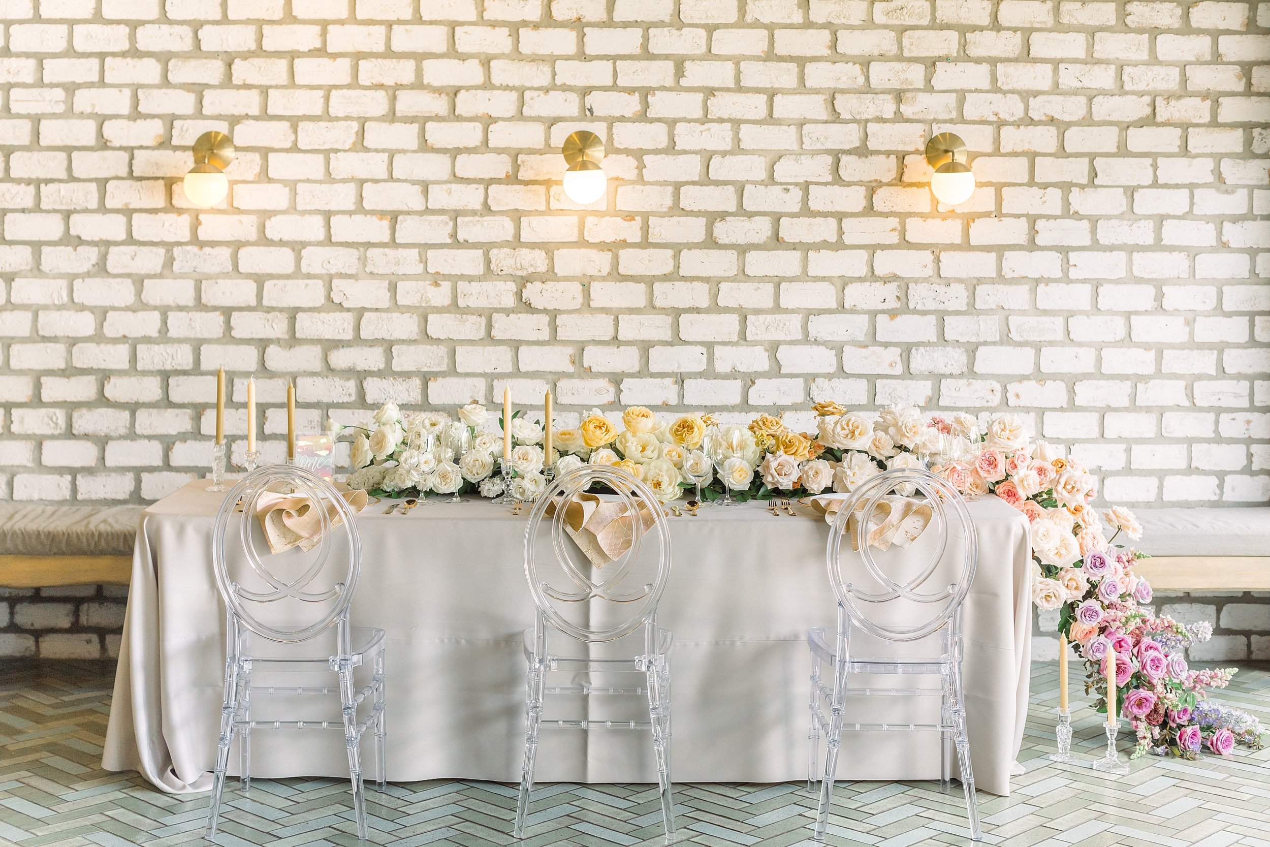 wide view of pride wedding editorial tablescape featuring ombre flower garland centerpiece